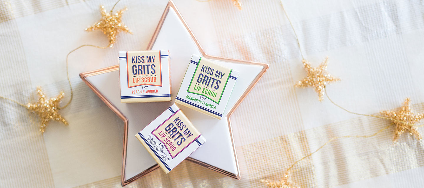 kiss my grits lip scrub boxes on a large star plate with gold stars